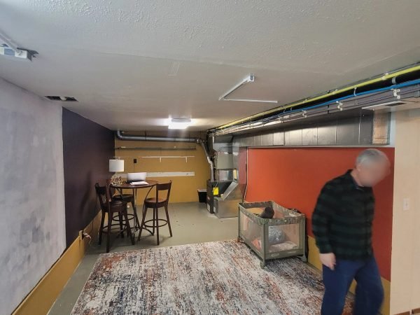 Interior basement living area showing new finishes and a rug in East Missoula.