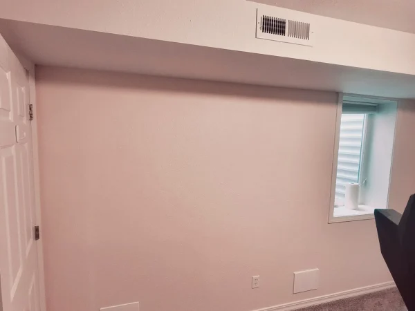 Finished basement wall with new baseboards and an HVAC vent in Missoula.
