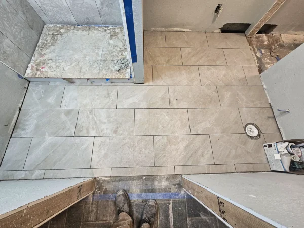 Bathroom floor tile transition in a Missoula remodel project.