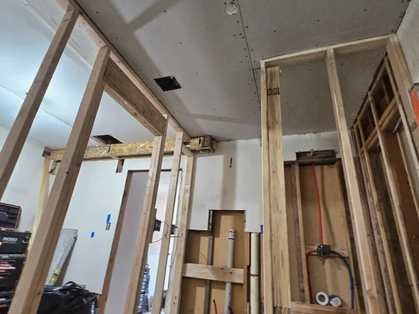 Hanging drywall on new bathroom walls during a remodel in Missoula.