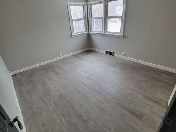 New LVP flooring and baseboard installation in a Missoula bedroom.