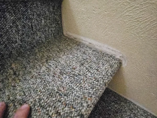 Close-up of reinstalled carpet on a repaired staircase in Missoula.