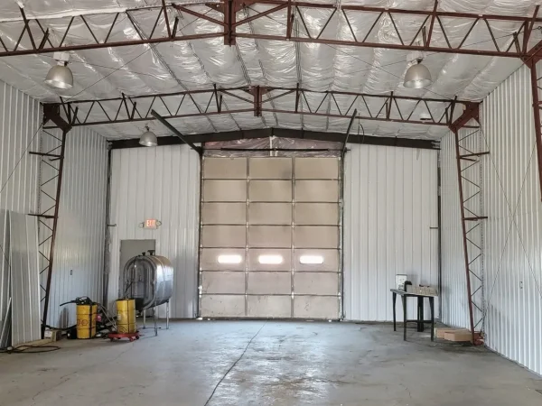 Commercial garage door before enclosure in a Missoula metal shop.