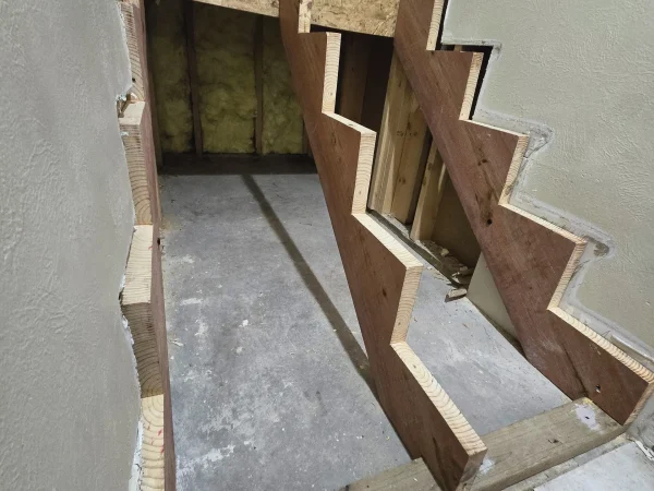 Custom pressure-treated stair stringers before tread installation in Missoula.