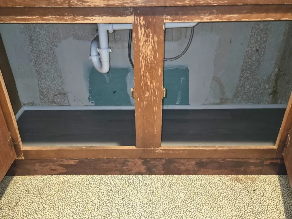 Finished kitchen cabinet with a custom-stained toe kick that matches the original wood finish.
