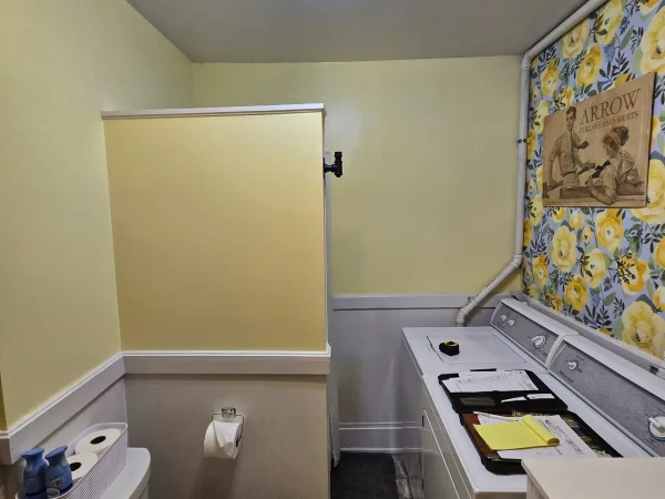 Finished historic bathroom and laundry remodel with yellow walls and wainscoting in Missoula.