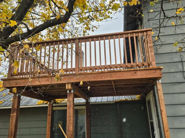 Completed wood deck with handrails and new door in East Missoula.
