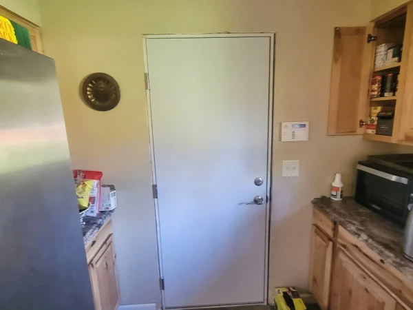Newly installed white fire-rated door leading to a garage in East Missoula MT