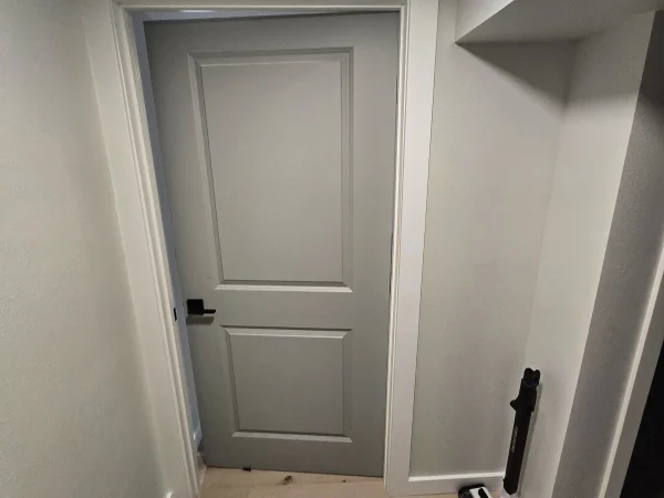 Gray two-panel interior door with white trim and black hardware in Missoula.