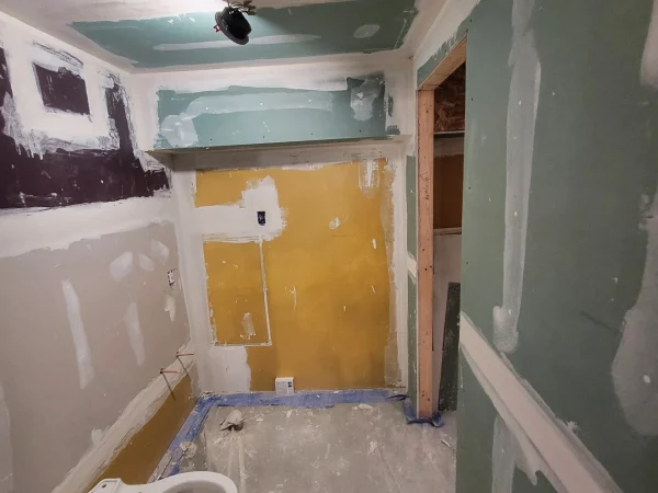 Drywall taping progress in a basement half-bathroom remodel in Missoula.