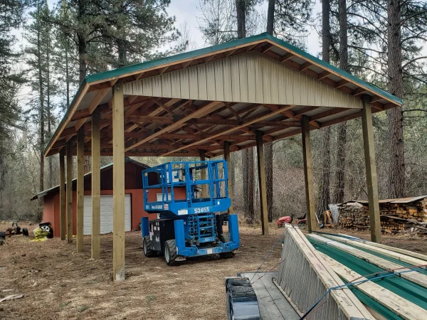 High-clearance RV port with forest green metal roofing in Missoula.