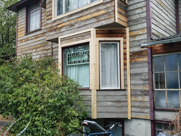 Custom exterior wood trim restoration on a historic Missoula home bay window.