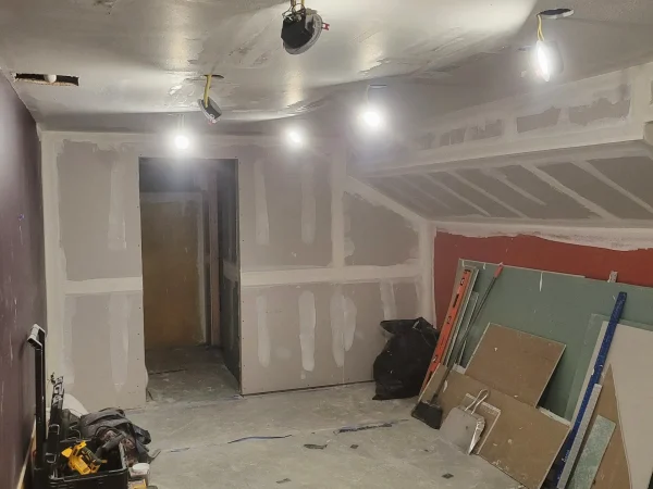 Taping and mudding drywall on a basement HVAC soffit in East Missoula.