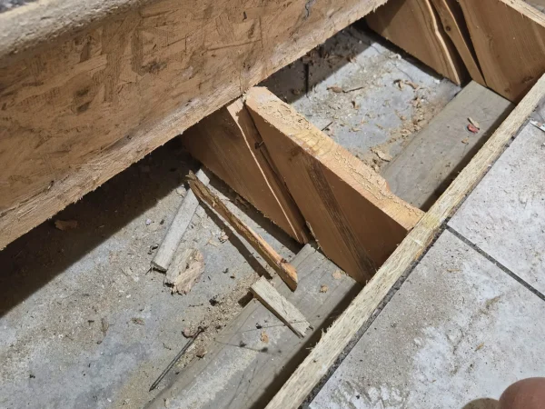 Improper stair framing showing stringers not resting on the concrete in Missoula.