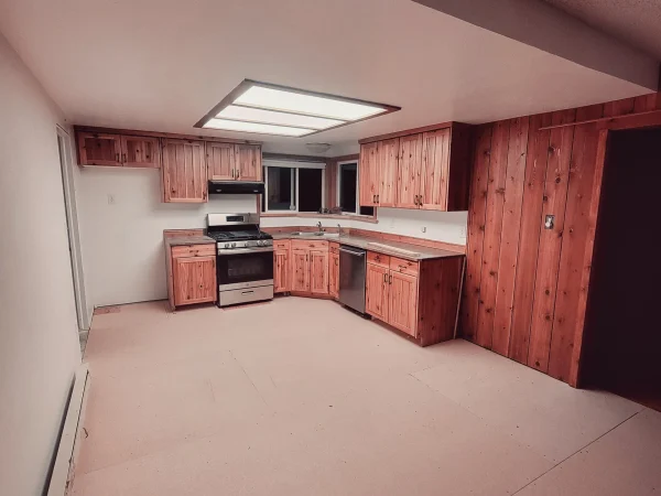 Kitchen restoration featuring reset cabinets and appliances after flood damage.