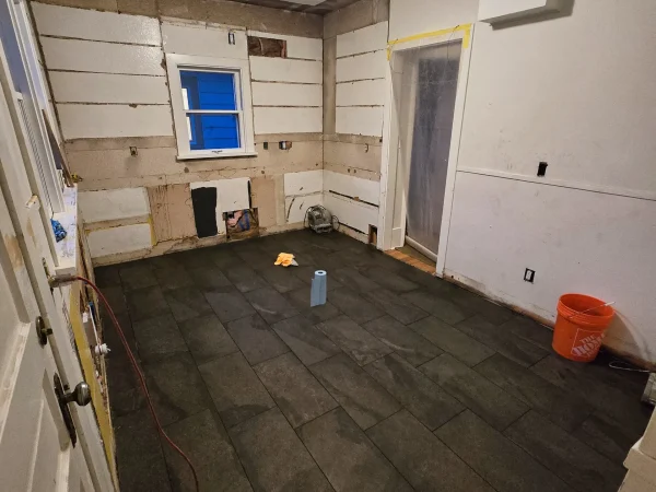 Kitchen tile flooring installation progress in Missoula.