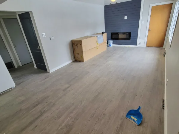 Living room remodel with LVP flooring and shiplap media wall in Missoula.