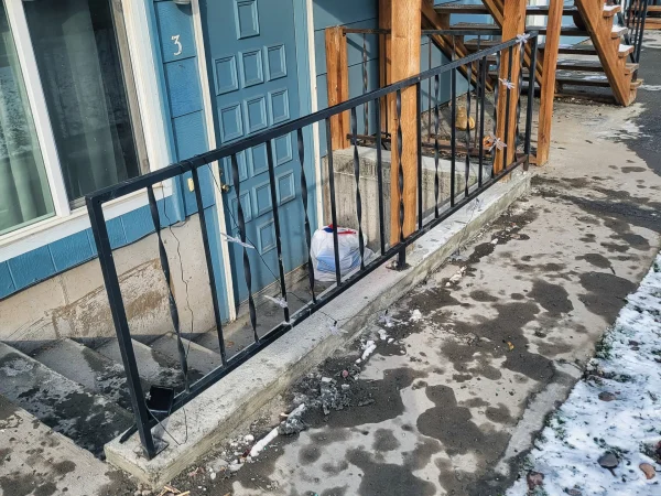 Metal handrail concrete base restoration in Missoula.