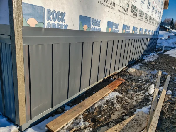 Close-up of metal wainscoting Z flashing on a Missoula exterior wall.
