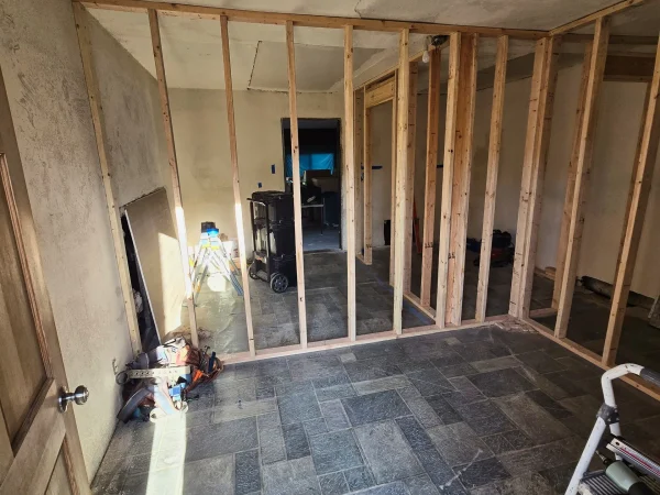 Wood stud framing for new interior rooms in Lewis and Clark Missoula.