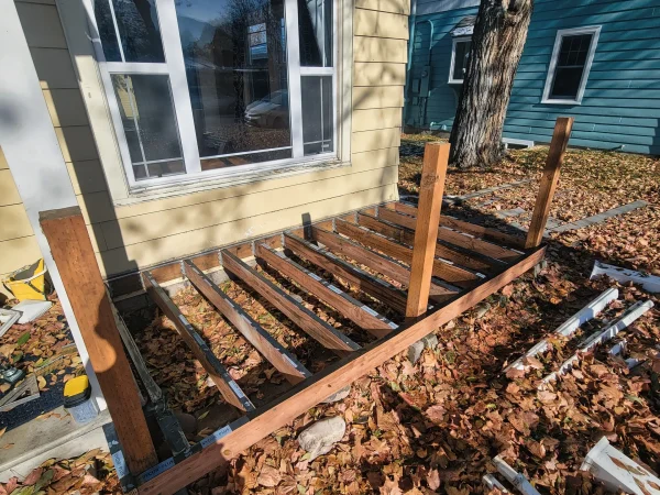 New pressure-treated deck framing with joist tape in Missoula.