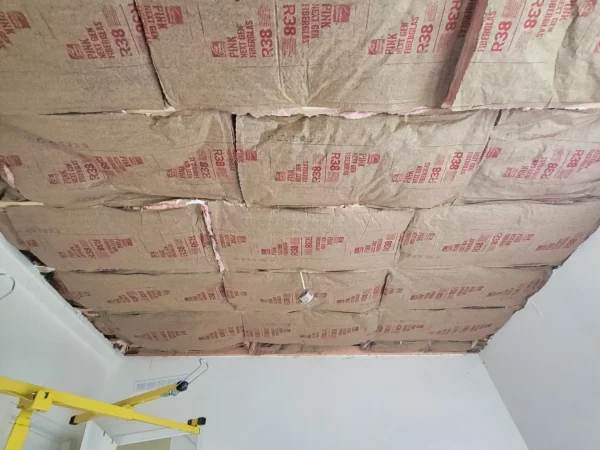 High-density R38 fiberglass batt insulation installed in a Missoula bedroom ceiling.