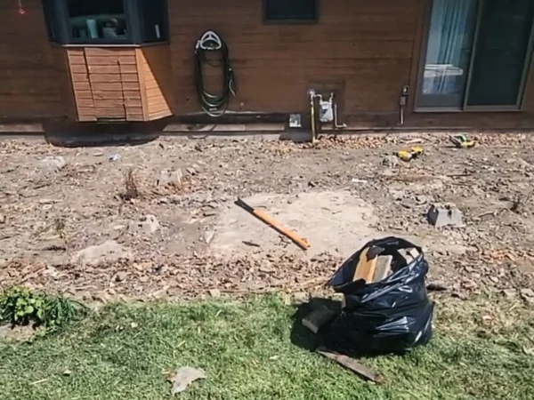 Rear of house showing cleared area after deck removal in Missoula.