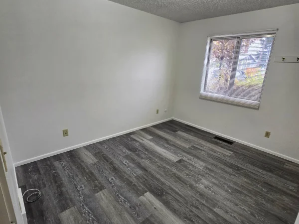 Finished interior bedroom with LVP flooring and white paint in Missoula.