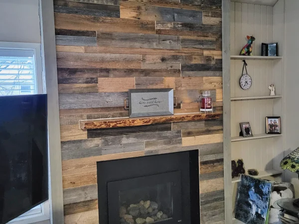 Close-up of randomized barnwood fireplace surround and repurposed floating mantel in Missoula.