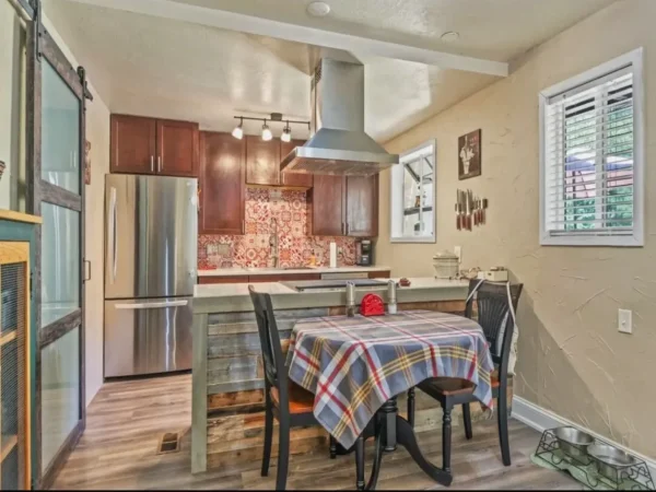 Rustic kitchen remodel with barnwood island and sliding barn door in Missoula.