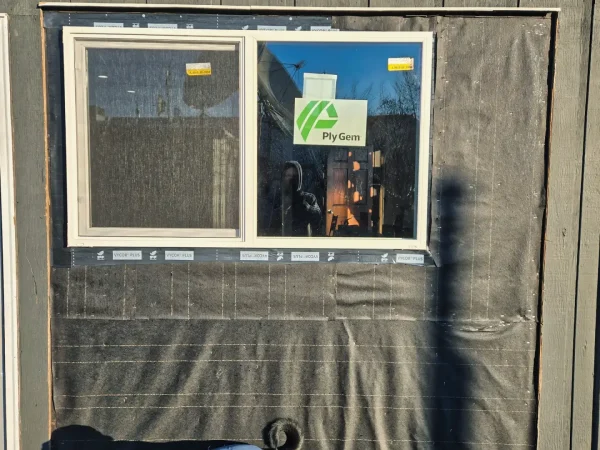 Vycor Plus flashing tape applied to window opening for waterproofing.